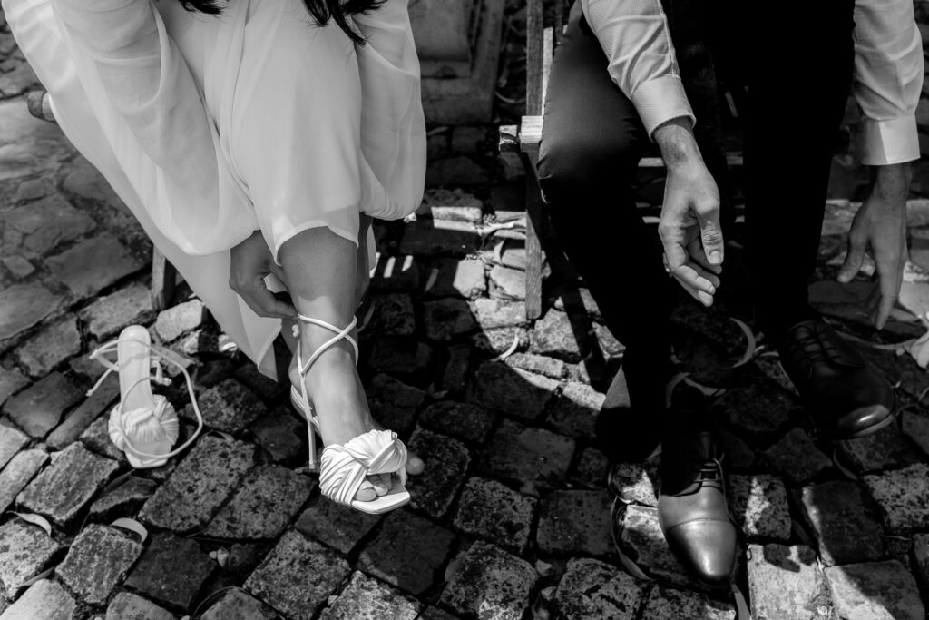 Couple getting ready for their wedding. Putting on their shoes.